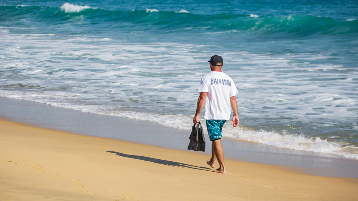 guy walking on beach