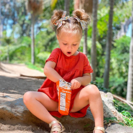 kid eating sweet orange